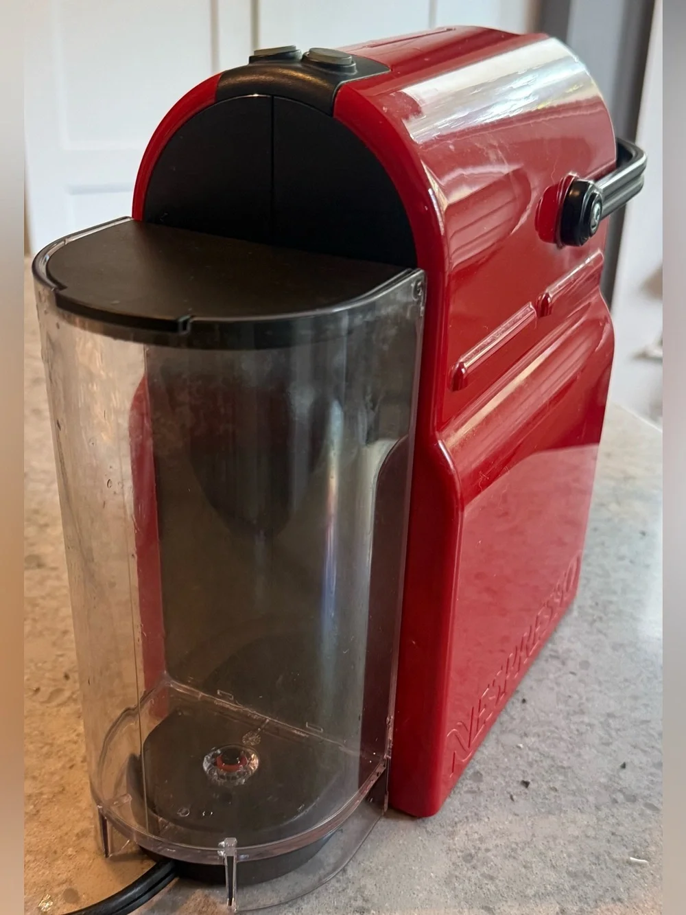 Nespresso Red Single-Serve Espresso Machine with Black Accents.